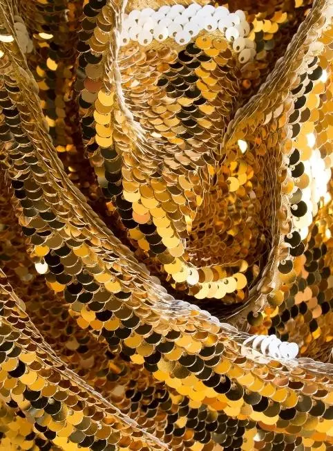Gold sequin fabric draped in folds